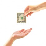 hand giving money to another