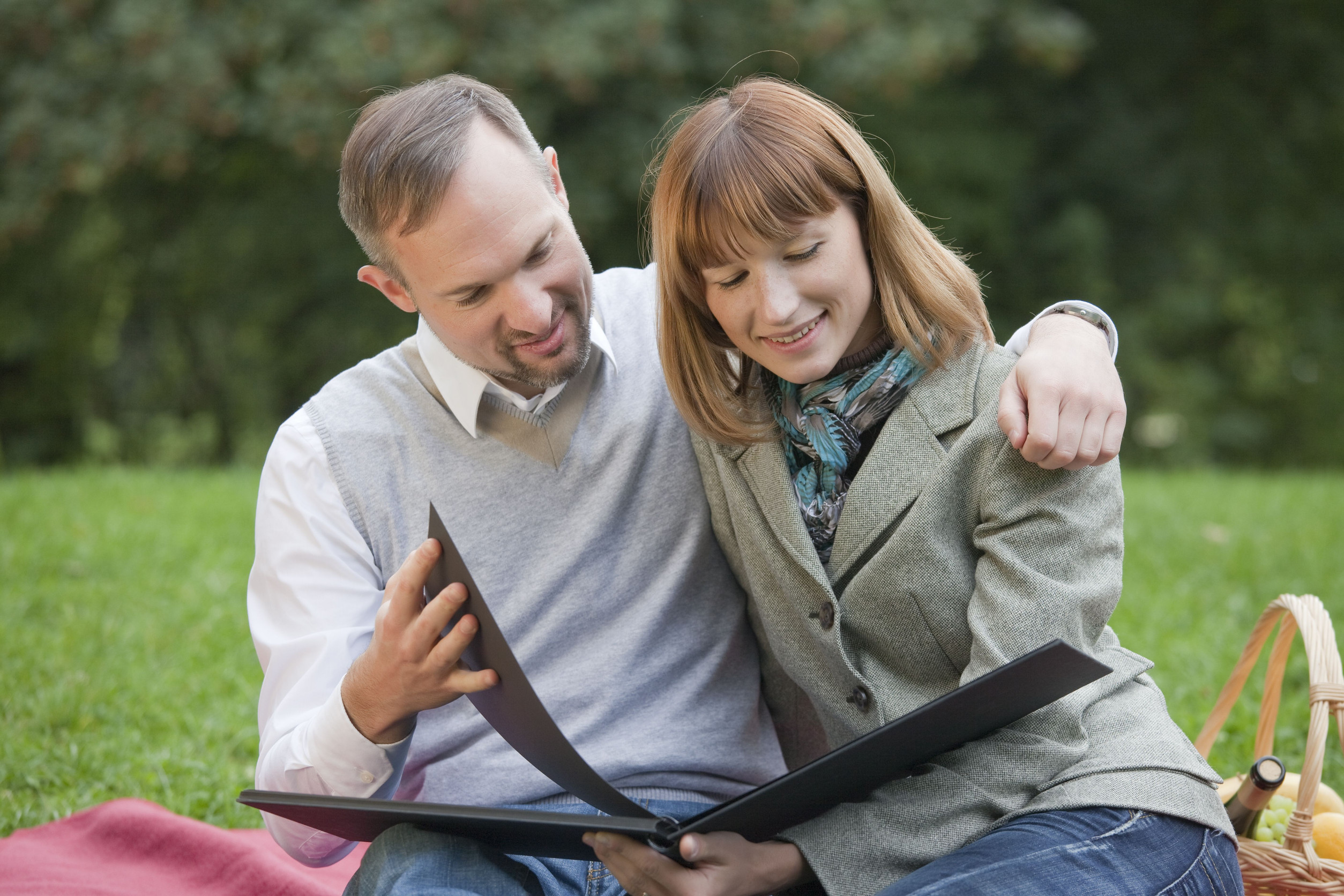 couple looking at photo book of meaningful relationship moments