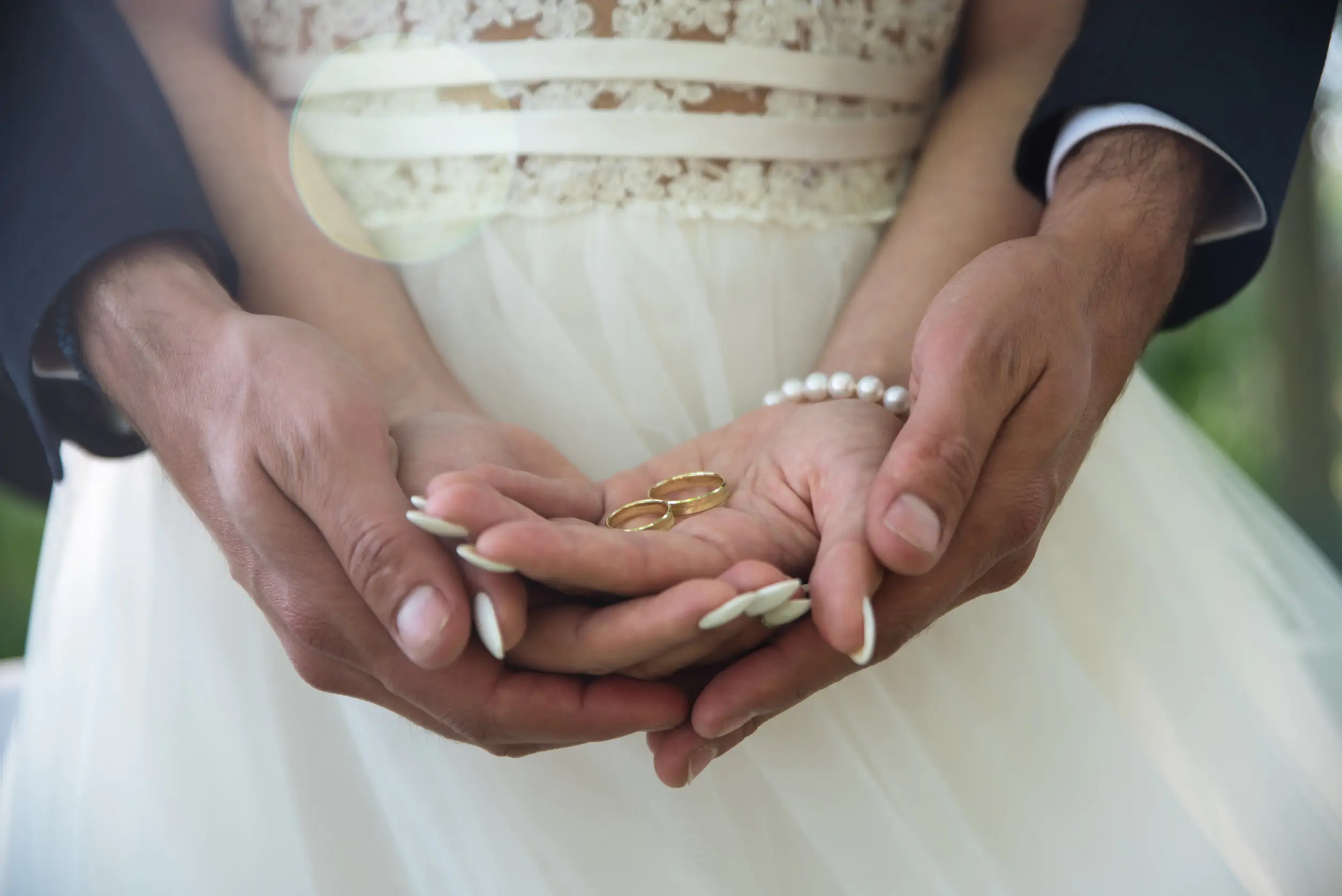 Two golden wedding rings on bride and groom's palms. Wedding rings on the palm